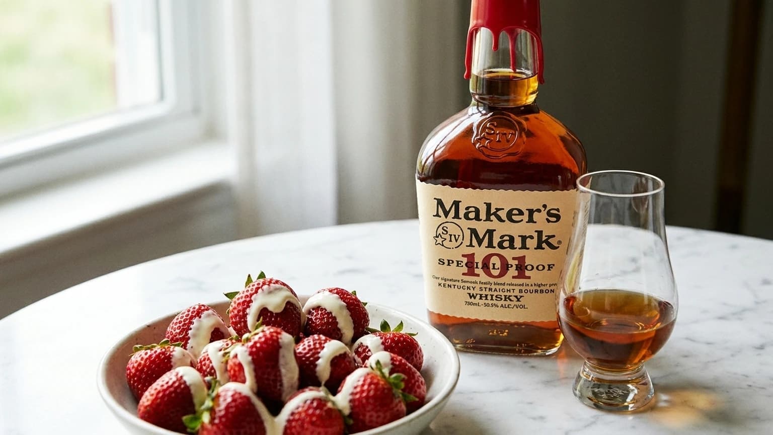 Bowl of strawberries and cream beside a bottle of Maker's Mark and a Glencairn of bourbon